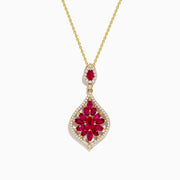 The Ruby Royale 14K Yellow Gold Ruby and Diamond Pendant features a teardrop ruby in a floral red gemstone pattern, accented with diamonds and an additional matching ruby above the main pendant.