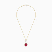 The Ruby Royale 14K Yellow Gold Ruby and Diamond Pendant features a teardrop ruby in a floral red gemstone pattern, accented with diamonds and an additional matching ruby above the main pendant.