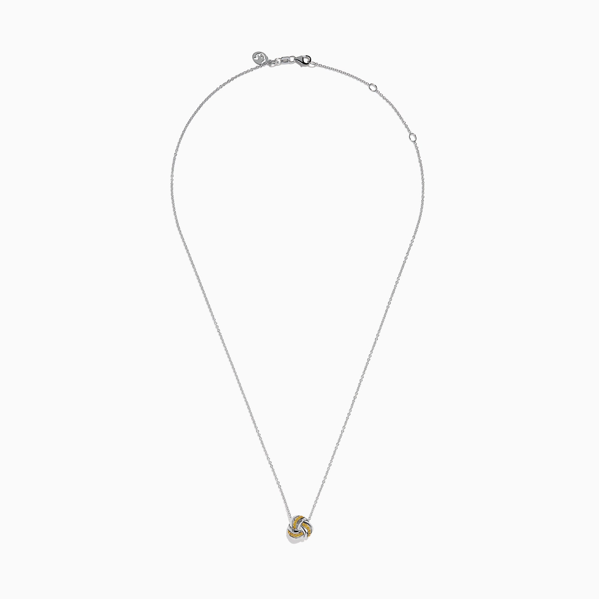 A 14K white gold love knot pendant with yellow diamonds hangs on a delicate chain, showcased against a white background.