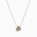 A 14K white gold love knot pendant with yellow diamonds hangs on a delicate chain, showcased against a white background.