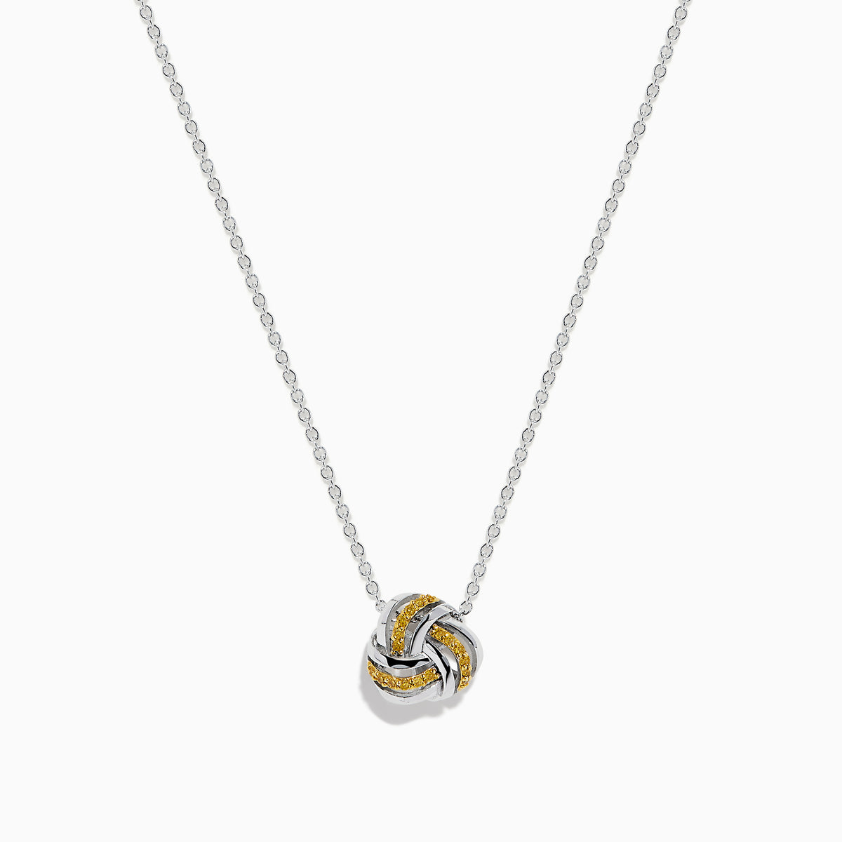 A 14K white gold love knot pendant with yellow diamonds hangs on a delicate chain, showcased against a white background.