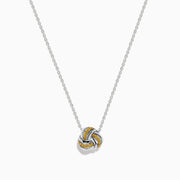 A 14K white gold love knot pendant with yellow diamonds hangs on a delicate chain, showcased against a white background.