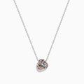 The 14K White Gold Pink Diamond Love Knot Pendant features intertwined rose gold and white gold tones with a polished, textured finish, delicately centered on a silver chain.
