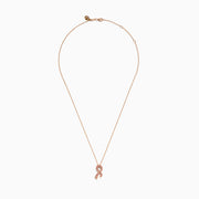 The 14K Rose Gold Pink Sapphire Ribbon Pendant features a pink ribbon-shaped charm encrusted with sparkling pink sapphires on a gold chain, displayed on a white background for a delicate, feminine look.