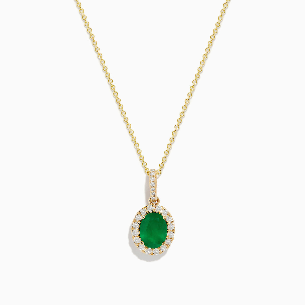 The 14K Yellow Gold Emerald and Diamond Pendant features an oval emerald surrounded by diamonds, suspended from a delicate gold chain and displayed against a white background.