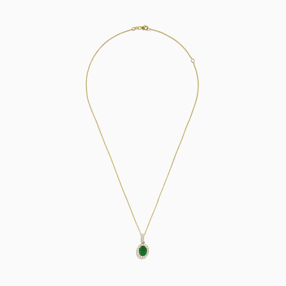 The 14K Yellow Gold Emerald and Diamond Pendant features an oval emerald surrounded by diamonds, suspended from a delicate gold chain and displayed against a white background.