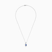 Elegant 14K white gold pendant featuring a curved design and centered with a round blue tanzanite, accented by diamonds, shown on a white background.