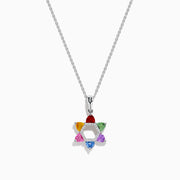 The Watercolors 14K White Gold Multi Color Sapphire and Diamond Star of David Pendant features six sapphires in red, orange, yellow, green, blue, and purple. It hangs from a delicate silver chain against a white background.
