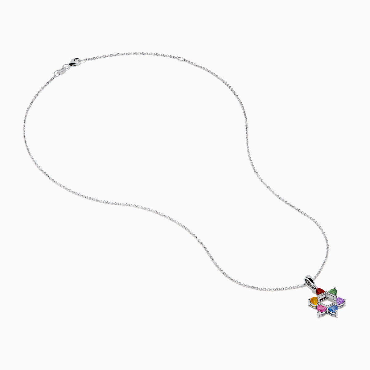 The Watercolors 14K White Gold Multi Color Sapphire and Diamond Star of David Pendant features six sapphires in red, orange, yellow, green, blue, and purple. It hangs from a delicate silver chain against a white background.