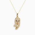 The Signature 14K Yellow Gold Sapphire and Diamond Panther Necklace features a panther-shaped pendant with sparkling diamond accents and vivid sapphire-blue eyes, all on a delicate gold chain, shown against a white background.