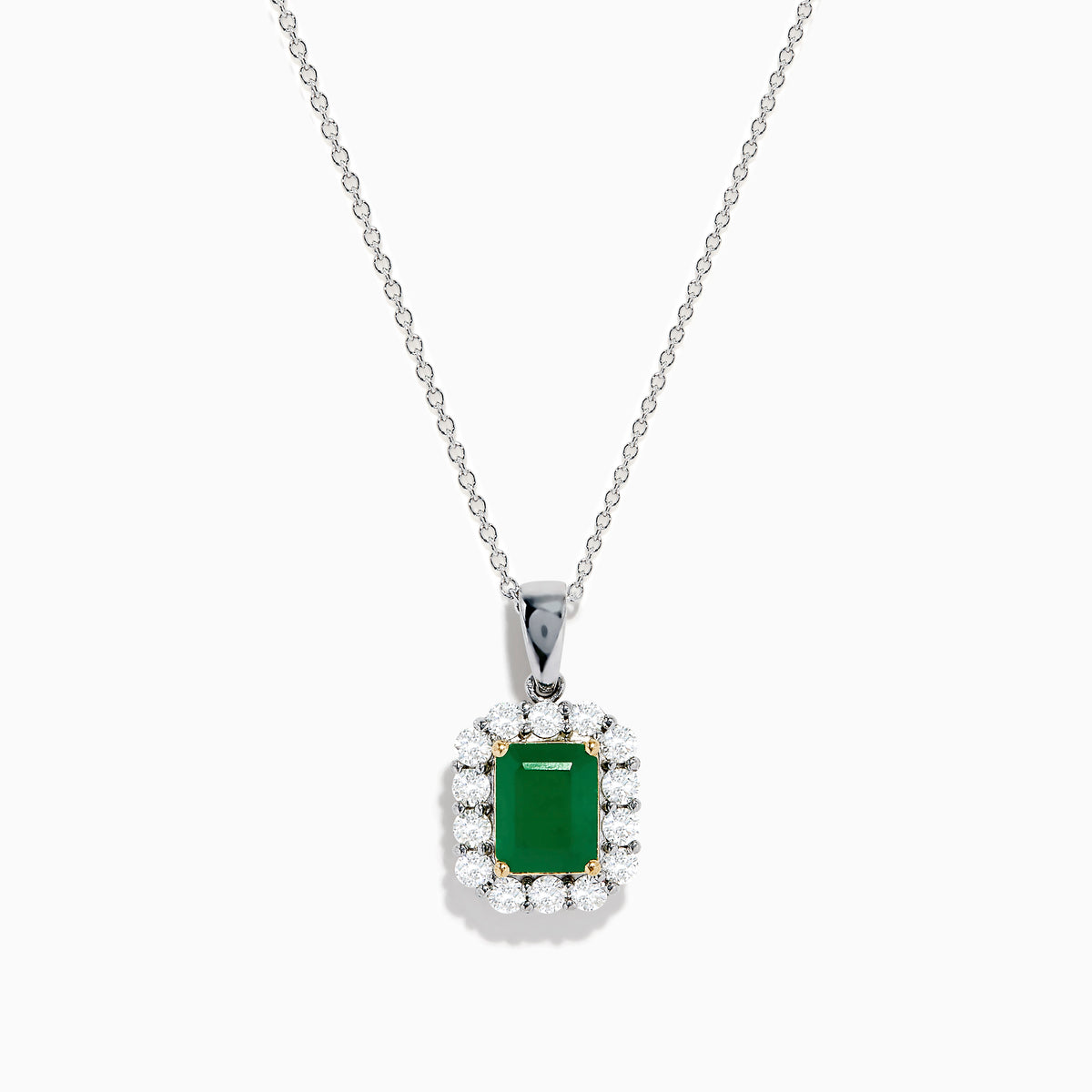 The Brasilica 14K Two-Tone Gold Emerald and Diamond Pendant features a rectangular emerald framed by sparkling diamonds, offering an elegant look reminiscent of a classic diamond pendant against a plain white background.