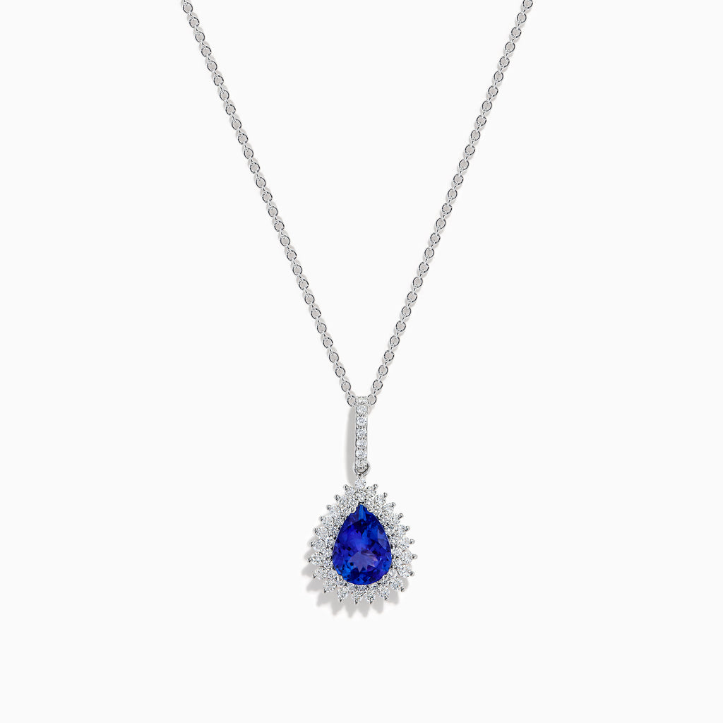 A 14K white gold pear tanzanite and diamond halo pendant with a diamond-studded bail, displayed on a white background.