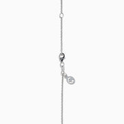A 14K white gold pear tanzanite and diamond halo pendant with a diamond-studded bail, displayed on a white background.