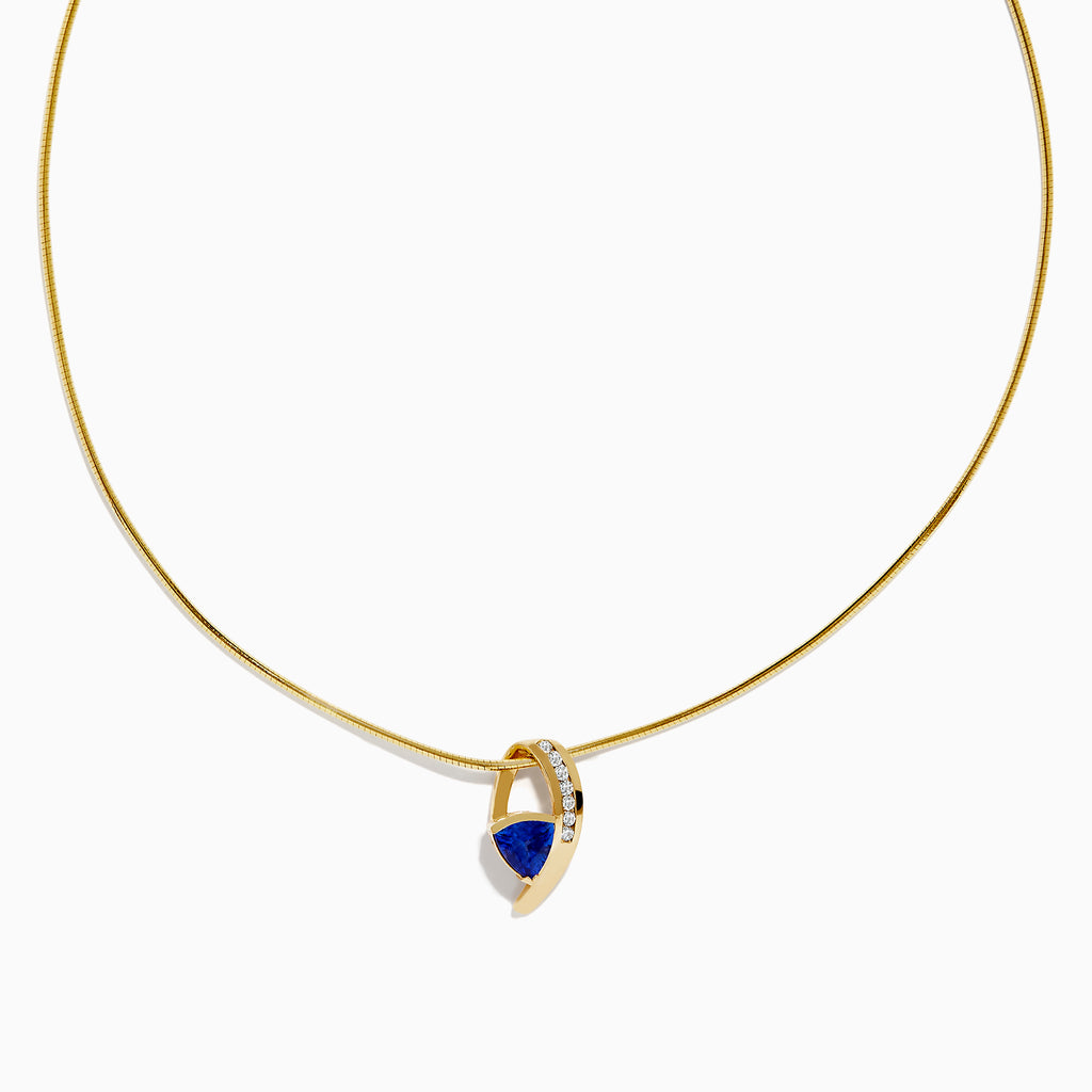 The Nahla Siri 14K Yellow Gold Tanzanite and Diamond Necklace features a delicate chain and a blue tanzanite gemstone pendant, accented with sparkling diamonds, displayed on a white background.