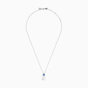 The Nahla 14K White Gold Fresh Water Pearl and Tanzanite Pendant features a round pearl accented with a small, triangular blue tanzanite, all set in white gold and shown against a plain white background.