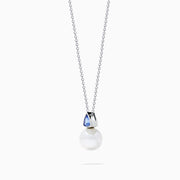 The Nahla 14K White Gold Fresh Water Pearl and Tanzanite Pendant features a round pearl accented with a small, triangular blue tanzanite, all set in white gold and shown against a plain white background.