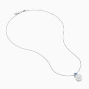 The Nahla 14K White Gold Fresh Water Pearl and Tanzanite Pendant features a round pearl accented with a small, triangular blue tanzanite, all set in white gold and shown against a plain white background.