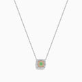 The 18K Two-Tone Gold Green and White Diamond Halo Necklace features a square pendant with a central green gemstone, accented by a double halo of sparkling white diamonds on a delicate chain.