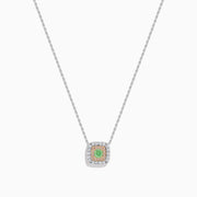 The 18K Two-Tone Gold Green and White Diamond Halo Necklace features a square pendant with a central green gemstone, accented by a double halo of sparkling white diamonds on a delicate chain.