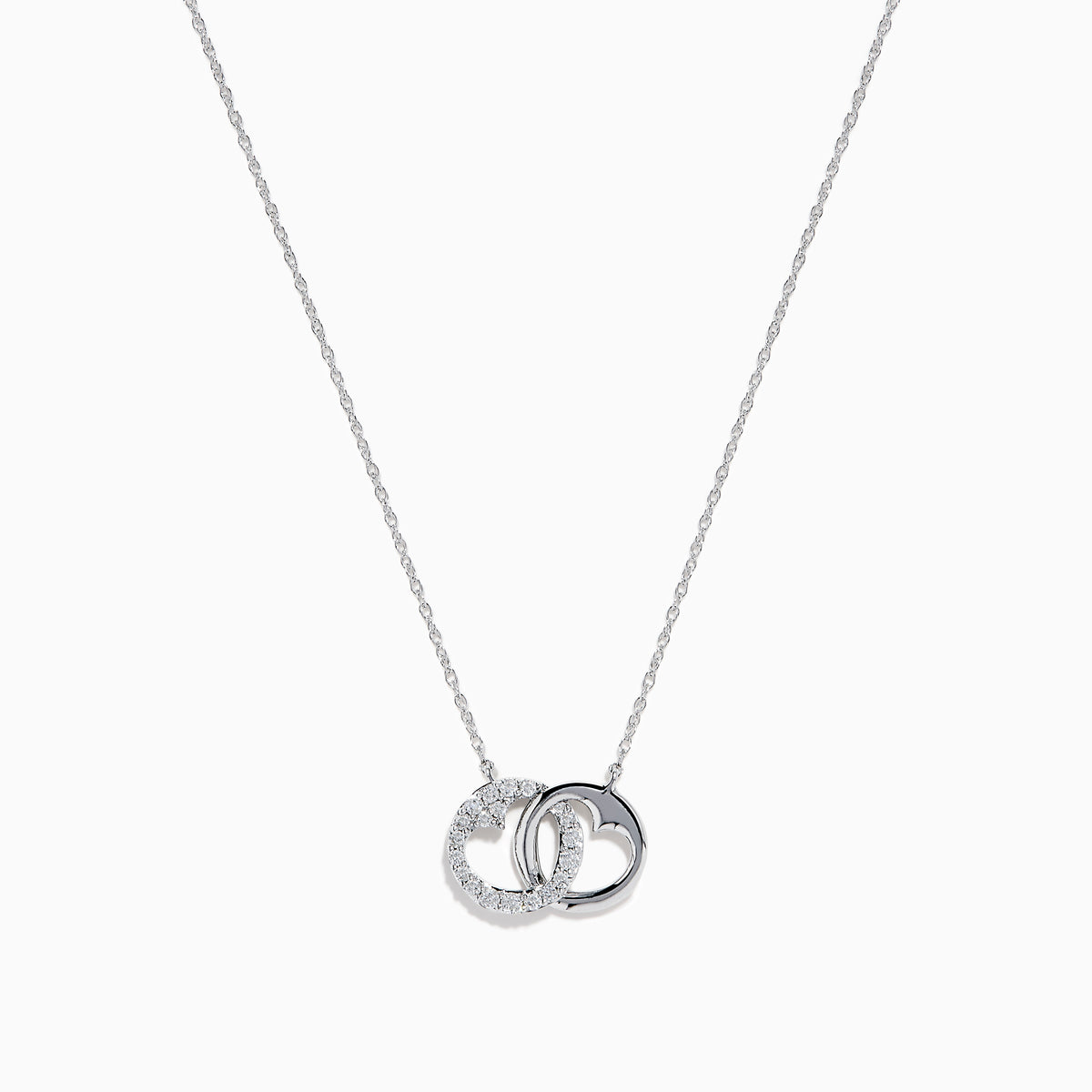 The 14K White Gold Diamond Accented Interlocking Hearts Necklace features two intertwined hearts—one with sparkling diamond accents, the other polished smooth—set on a plain white background.