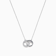 The 14K White Gold Diamond Accented Interlocking Hearts Necklace features two intertwined hearts—one with sparkling diamond accents, the other polished smooth—set on a plain white background.