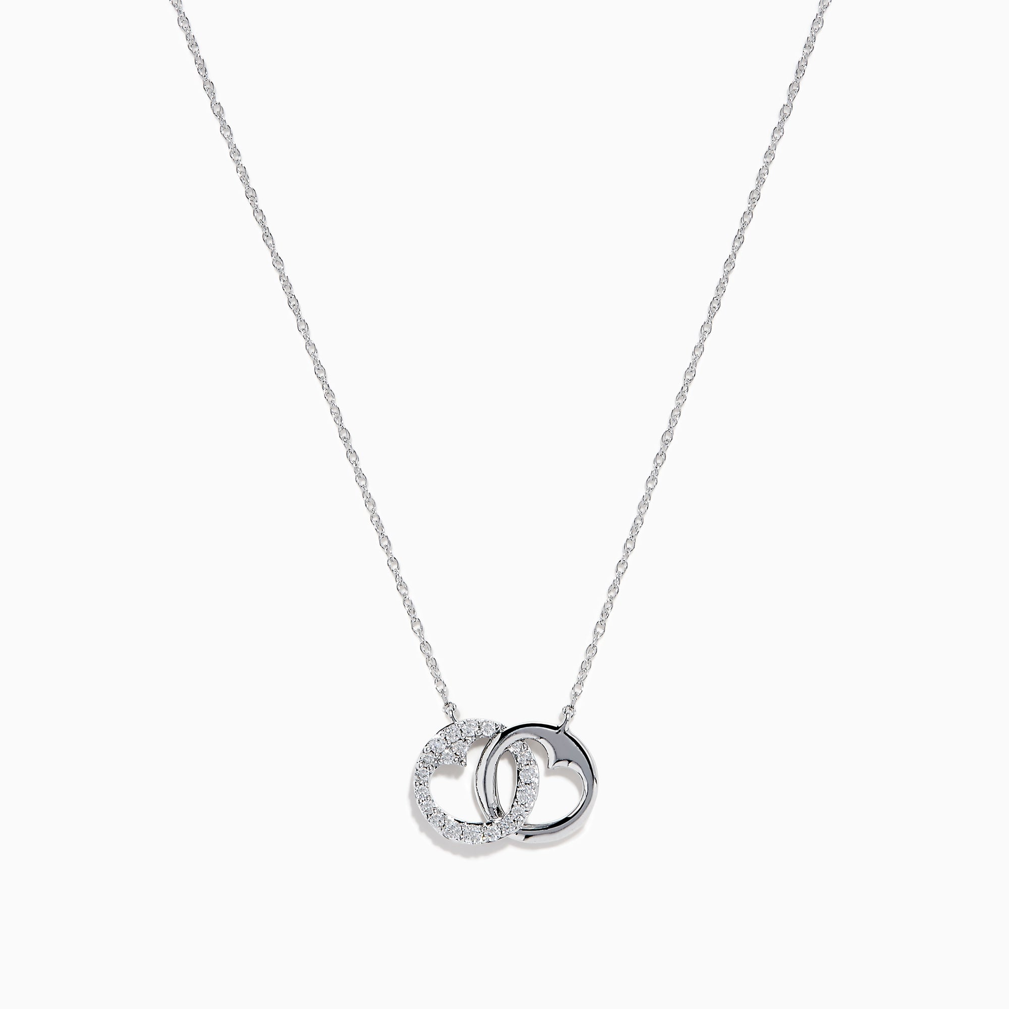 The 14K White Gold Diamond Accented Interlocking Hearts Necklace features two intertwined hearts—one with sparkling diamond accents, the other polished smooth—set on a plain white background.