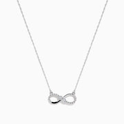 The 14K White Gold Diamond Accented Infinity Necklace features a sparkling infinity symbol pendant and is shown on a plain white background.