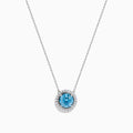 The Lab Grown Blue and White Diamond Halo Necklace in 14K White Gold features a round blue gemstone pendant encircled by sparkling lab grown diamonds, shown against a white background.
