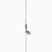The Lab Grown Blue and White Diamond Halo Necklace in 14K White Gold features a round blue gemstone pendant encircled by sparkling lab grown diamonds, shown against a white background.