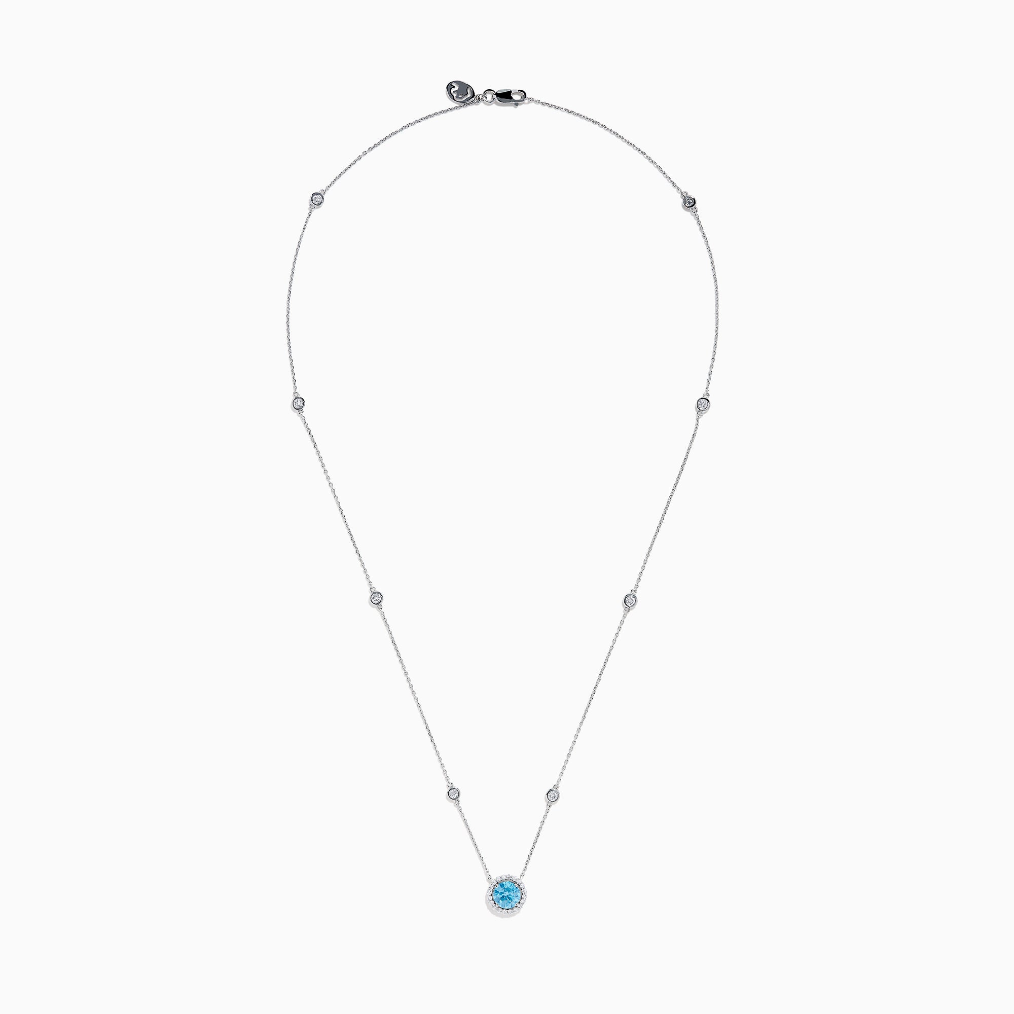 The Lab Grown Blue and White Diamond Halo Necklace in 14K White Gold features a round blue gemstone pendant surrounded by lab grown diamonds, plus two small clear stones set along the chain.
