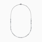 The Lab Grown Multi Shape Diamond 7.25ct Tennis Necklace in 14K White Gold features round, marquise, and emerald cut lab-grown diamonds arranged evenly along the chain and is shown gracefully curved on a white background.