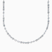 The Lab Grown Multi Shape Diamond 7.25ct Tennis Necklace in 14K White Gold features round, marquise, and emerald cut lab-grown diamonds arranged evenly along the chain and is shown gracefully curved on a white background.