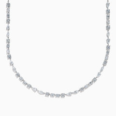 The Lab Grown Multi Shape Diamond 7.25ct Tennis Necklace in 14K White Gold features round, marquise, and emerald cut lab-grown diamonds arranged evenly along the chain and is shown gracefully curved on a white background.