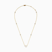 The Lab Grown Diamond Pear Station Necklace in 14K Yellow Gold features a large pear-shaped lab diamond pendant and two small round lab diamonds set along a delicate gold chain.