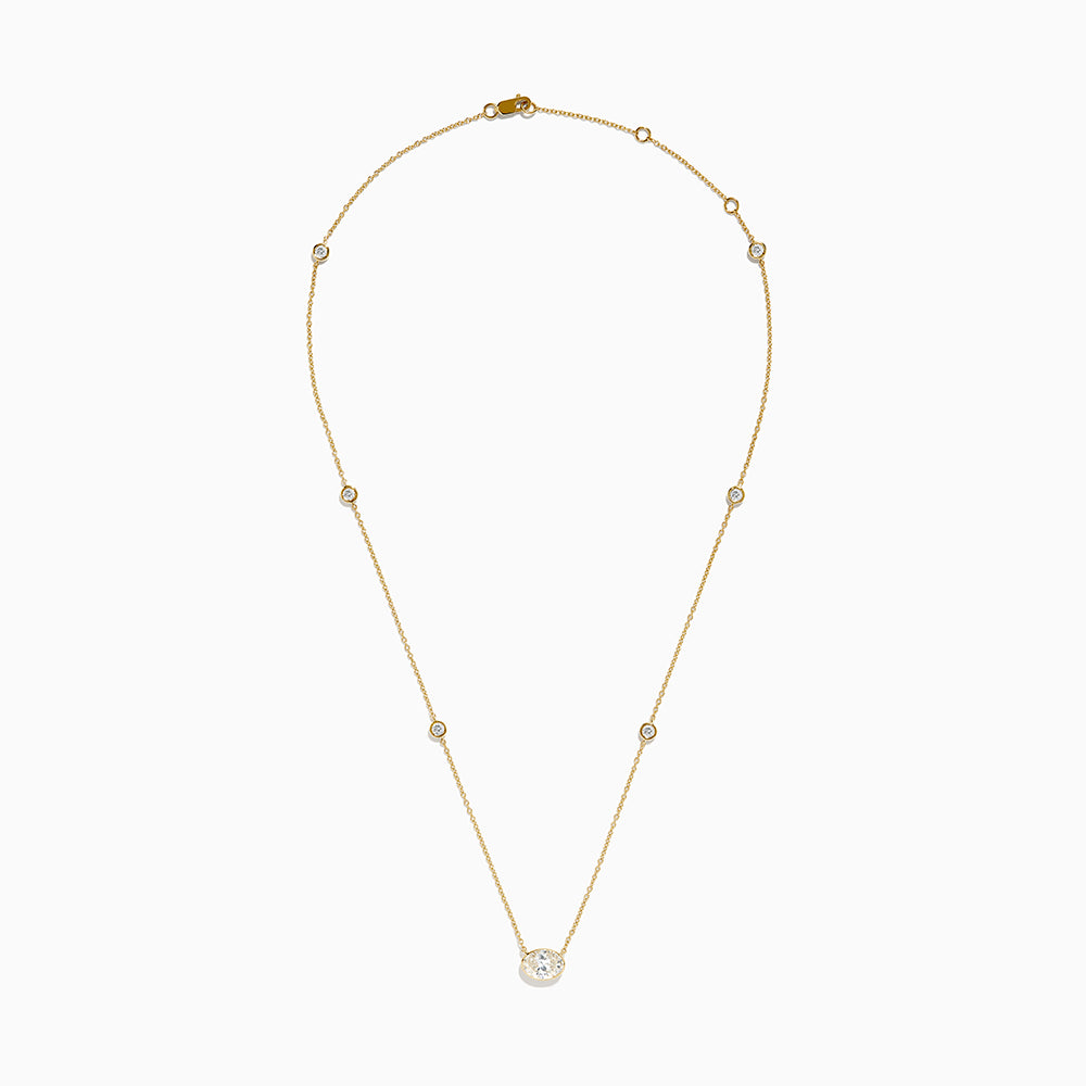 The Lab Grown Diamond Oval Station Necklace in 14K Yellow Gold features a central oval-shaped diamond pendant and two small round diamonds set along each side of the chain, creating an elegant, delicate look.