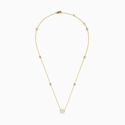 The Lab Grown Diamond Oval Station Necklace in 14K Yellow Gold features a central oval-shaped diamond pendant and two small round diamonds set along each side of the chain, creating an elegant, delicate look.
