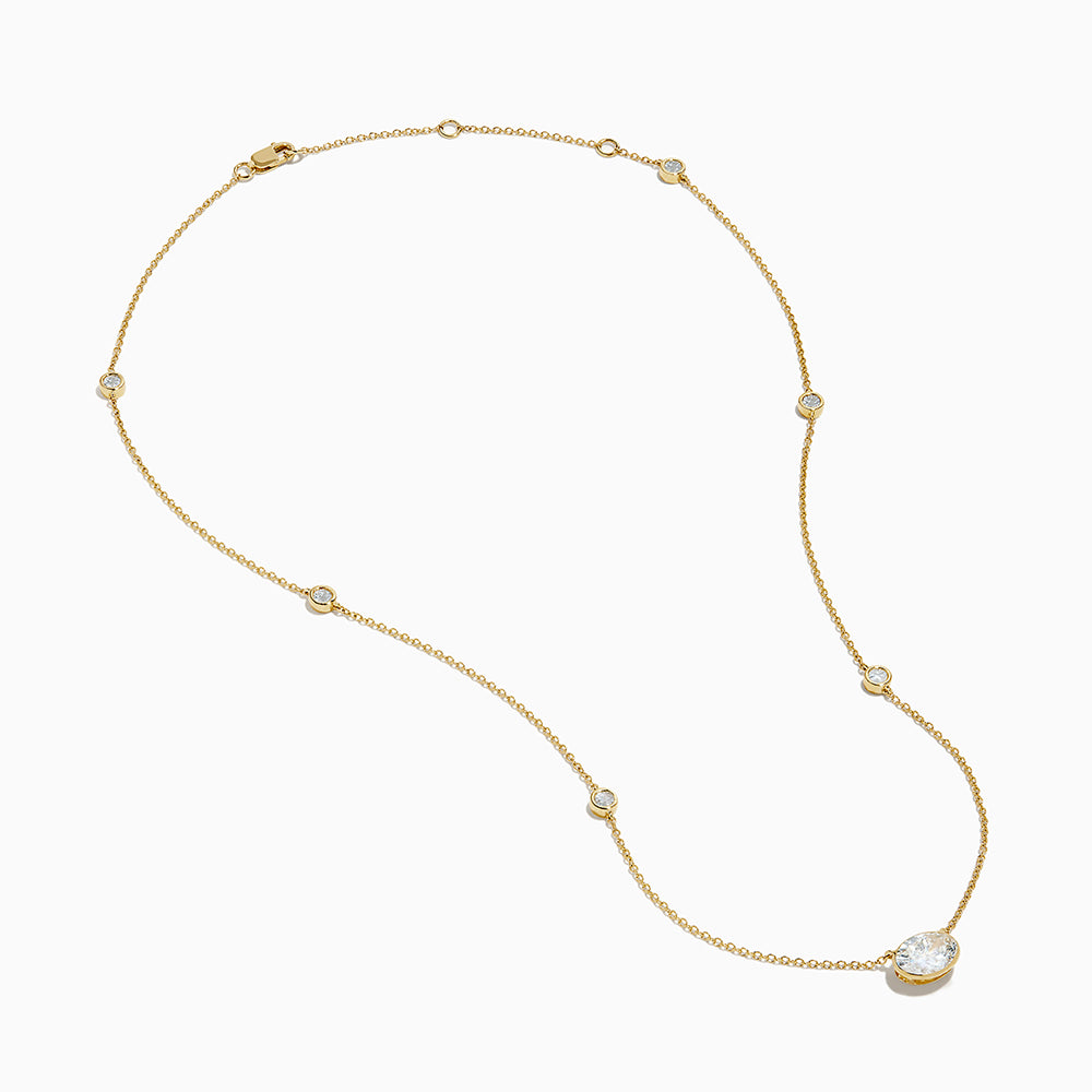 The Lab Grown Diamond Oval Station Necklace in 14K Yellow Gold features a central oval-shaped diamond pendant and two small round diamonds set along each side of the chain, creating an elegant, delicate look.