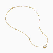The Lab Grown Diamond Oval Station Necklace in 14K Yellow Gold features a central oval-shaped diamond pendant and two small round diamonds set along each side of the chain, creating an elegant, delicate look.