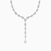 The Lab Grown Diamond Lariat Tennis Necklace in 14K White Gold showcases alternating round and rectangular lab grown diamonds, ending with a pear-shaped drop for an elegant, symmetrical look.