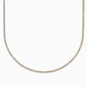 The Lab Grown Diamond 4.9ct Tennis Necklace in 14K Yellow Gold features small, evenly spaced lab grown diamonds in a continuous sparkling line, shown against a plain white background.