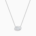 The Lab Grown Diamond East-West Oval Halo Necklace in 14K White Gold showcases a clear lab grown diamond pendant encircled by sparkling stones in an elegant halo setting.