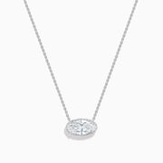 The Lab Grown Diamond East-West Oval Halo Necklace in 14K White Gold showcases a clear lab grown diamond pendant encircled by sparkling stones in an elegant halo setting.