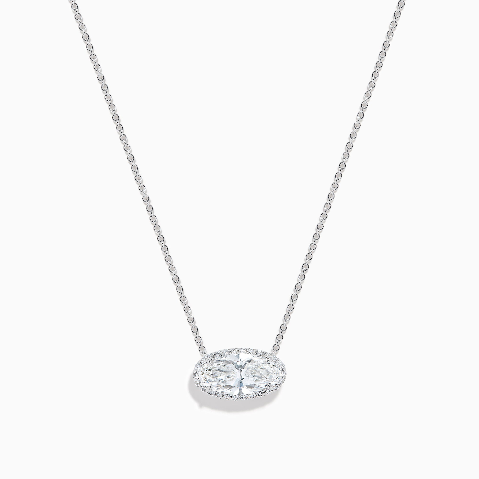The Lab Grown Diamond East-West Oval Halo Necklace in 14K White Gold showcases a clear lab grown diamond pendant encircled by sparkling stones in an elegant halo setting.