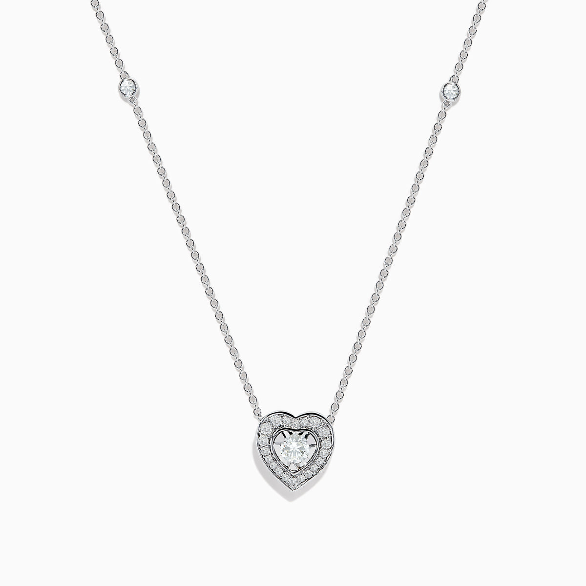 The Pave Classica 14K White Gold Diamond Heart Necklace features a heart-shaped pendant with a central diamond, surrounded by smaller diamonds, and two additional diamonds set along the chain.