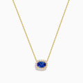 The Nahla 14K White Gold Tanzanite and Diamond Halo Necklace features a central blue oval tanzanite gemstone encircled by diamonds, shown on a white background.