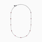 The Ruby Royale 925 Sterling Silver Necklace showcases alternating bezel-set rubies and diamonds along a delicate chain, elegantly displayed against a plain white background.
