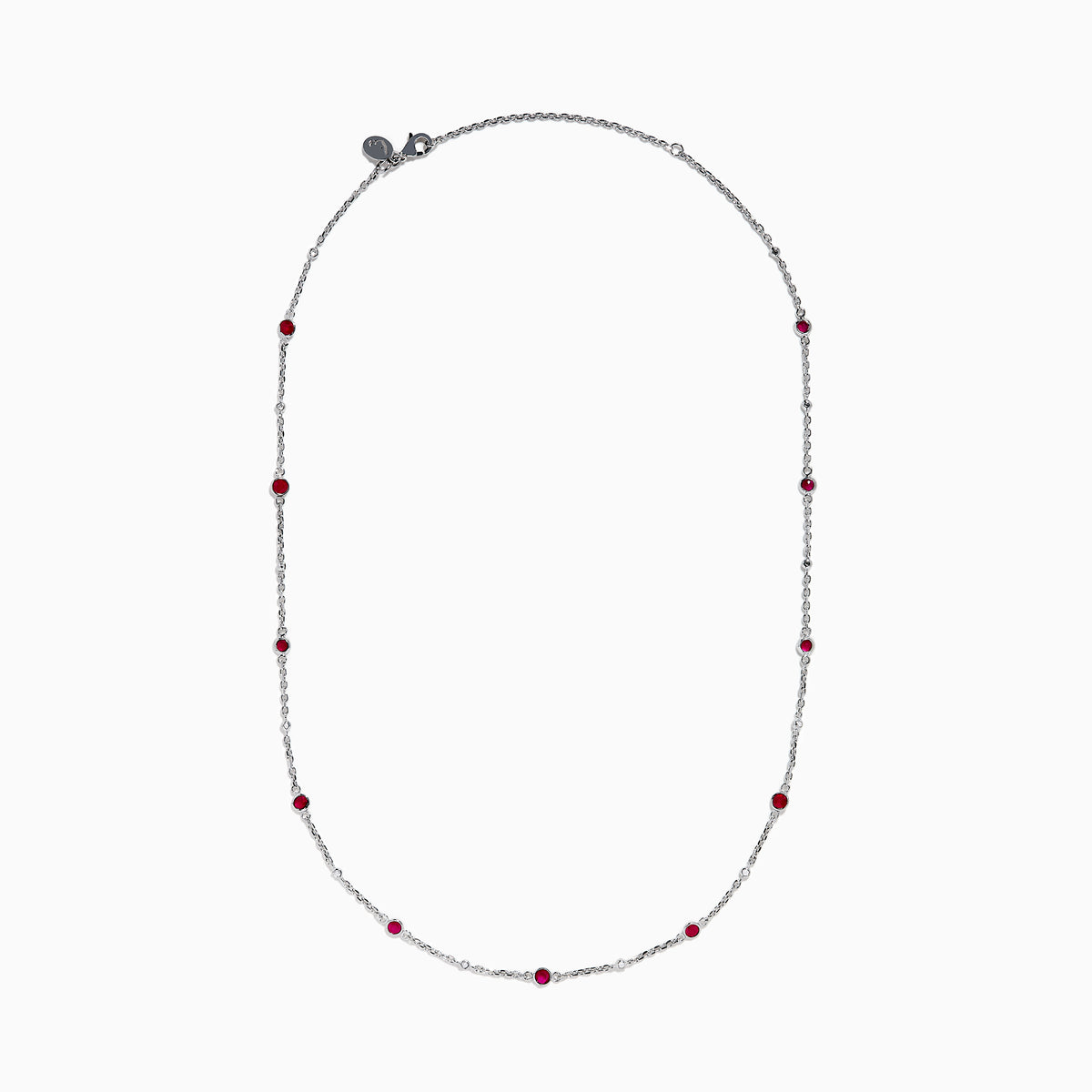 The Ruby Royale 925 Sterling Silver Necklace showcases alternating bezel-set rubies and diamonds along a delicate chain, elegantly displayed against a plain white background.