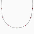 The Ruby Royale 925 Sterling Silver Necklace showcases alternating bezel-set rubies and diamonds along a delicate chain, elegantly displayed against a plain white background.