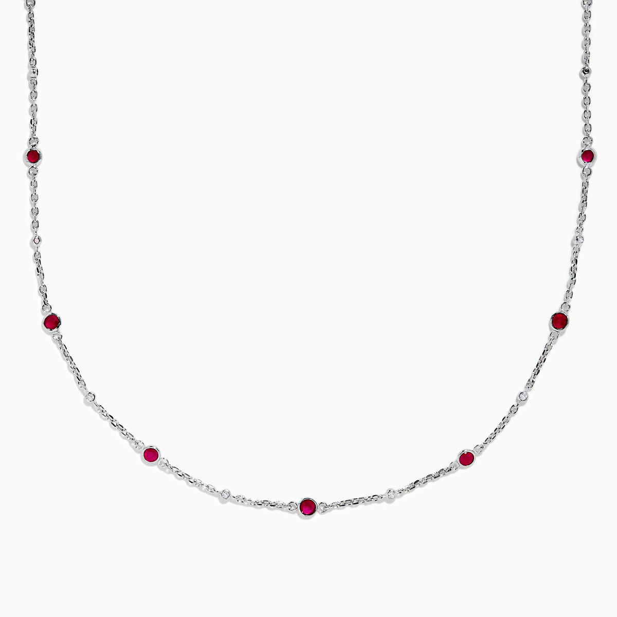 The Ruby Royale 925 Sterling Silver Necklace showcases alternating bezel-set rubies and diamonds along a delicate chain, elegantly displayed against a plain white background.