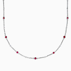 The Ruby Royale 925 Sterling Silver Necklace showcases alternating bezel-set rubies and diamonds along a delicate chain, elegantly displayed against a plain white background.